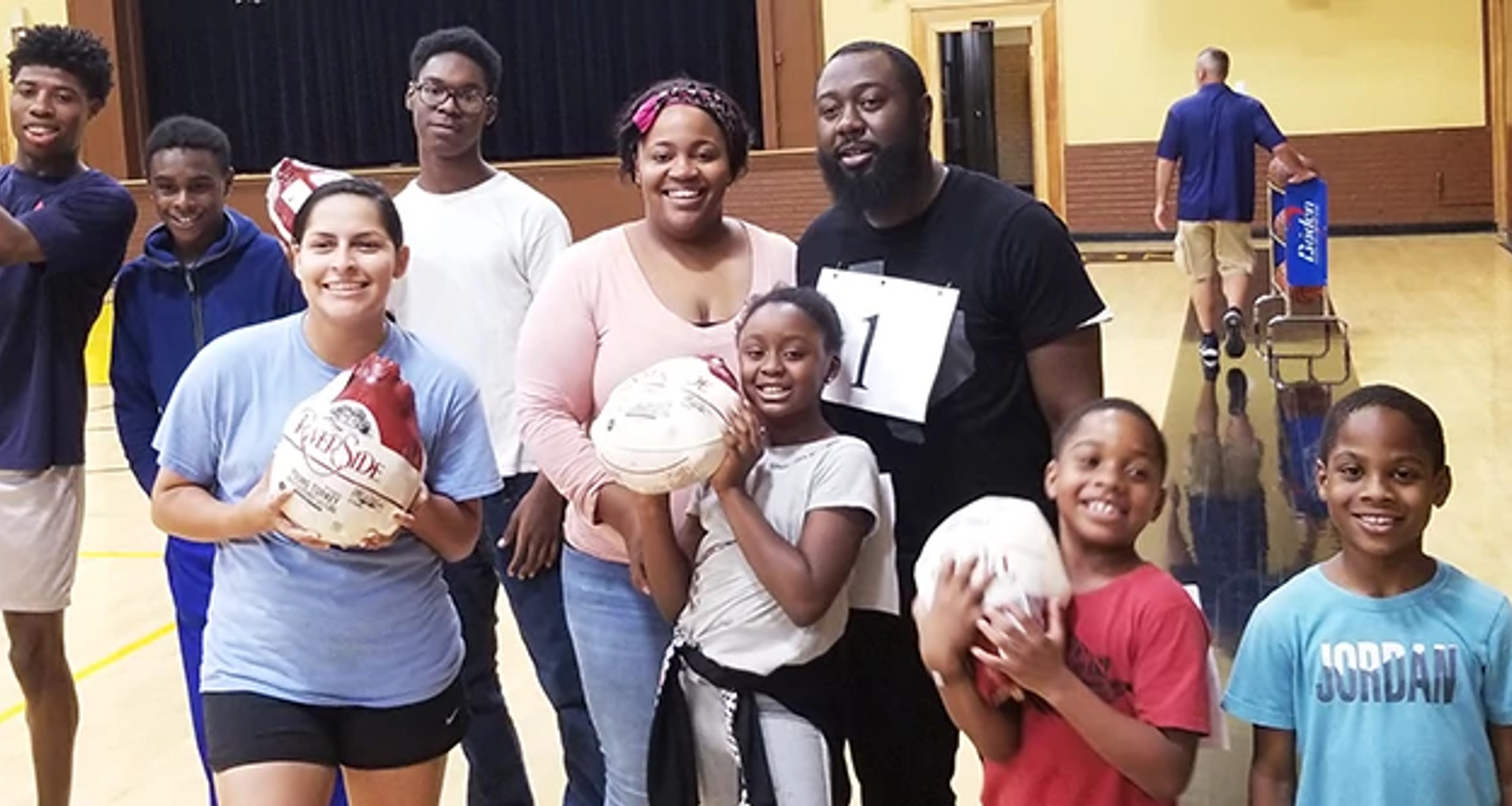 Group of people celebrating winning frozen turkeys